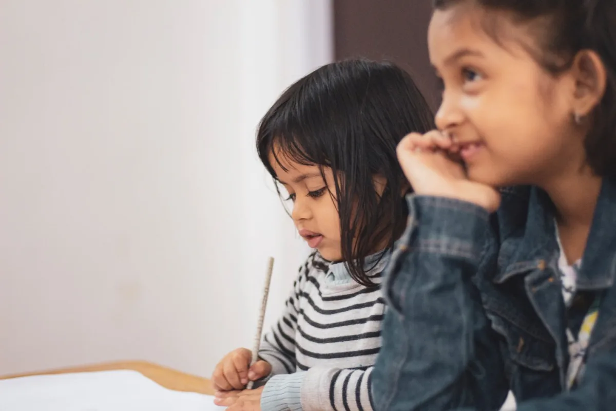 Two young pupils working at a table