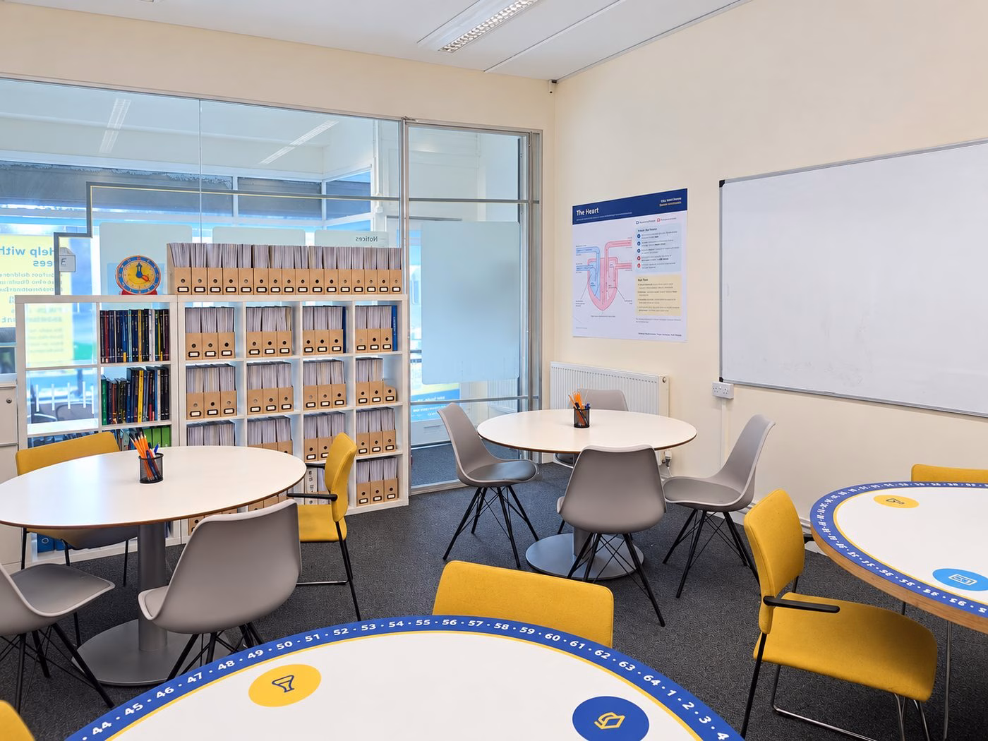 Bright classroom at Hackney Tuition Centre with round tables